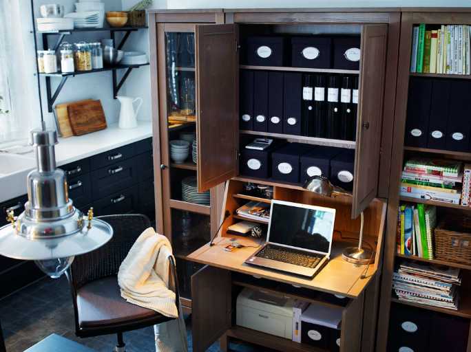 Ikea workspace in a cupboard that can collapse to hide the equipment
